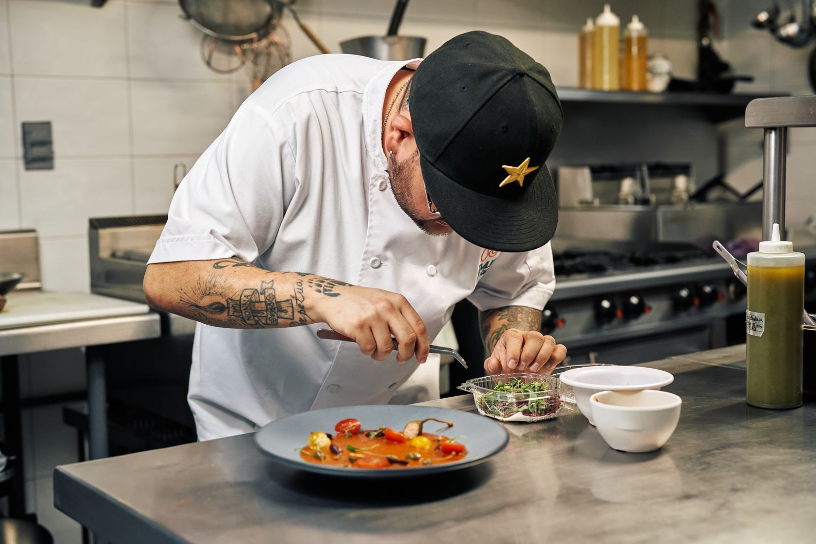 Chef carefully plating a dish in a restaurant kitchen